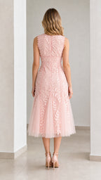 Back view of pink midi dress showing zipper and mesh flare