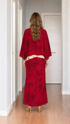 Model wearing red tie-dye two-piece set from the back