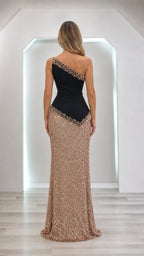 Model wearing black and gold one-shoulder sequin evening dress, back view