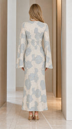 Back view showcasing capelet and straight maxi silhouette