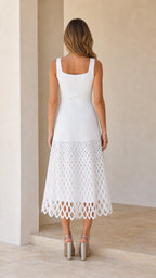Back view of woman wearing white midi dress showing square back
