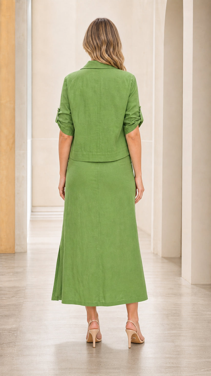 Back view of woman wearing green shirt and maxi skirt