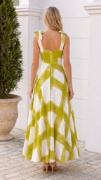 Back view of woman in white and green brushstroke maxi dress