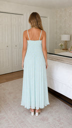Back view of model showing adjustable straps on light blue dress