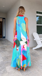 Back view of model wearing blue tropical print maxi dress