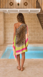 Back view of model showcasing the draped one-shoulder leopard dress