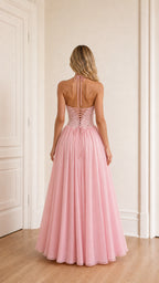Model wearing pink evening dress back view showing lace-up detail