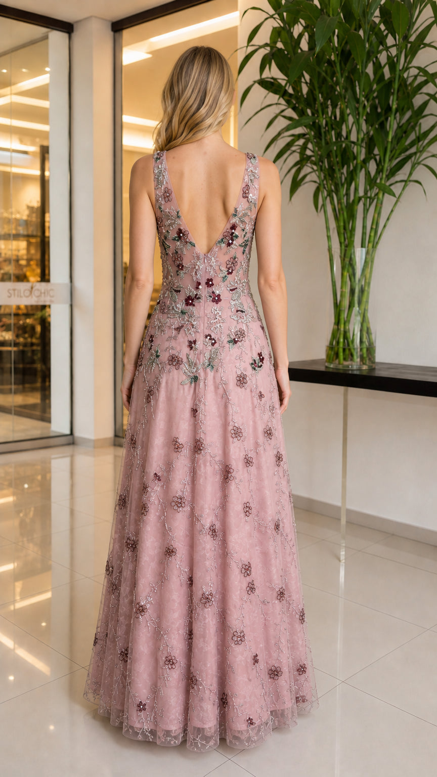 Back view of model showing V-back design of blush pink gown