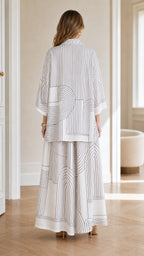 Back view of model wearing white shirt and wide leg pants
