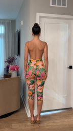 Back view showcasing open back design of multi floral jumpsuit