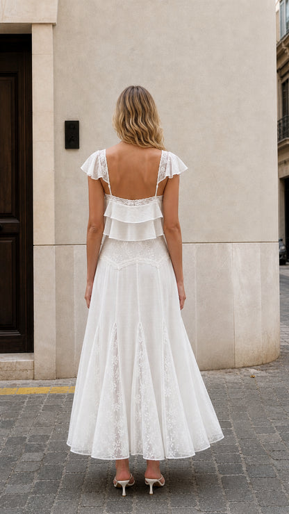 Back view of woman wearing white ruffled two-piece maxi set