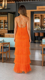 Back view highlighting lace-up strap details on orange fringe dress