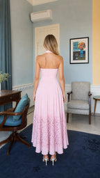 Back view of model wearing pink halter neck long dress