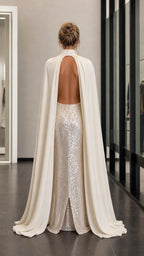 Back view showcasing flowing cape and open back detail
