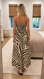 Back view of woman wearing brown zebra print maxi dress