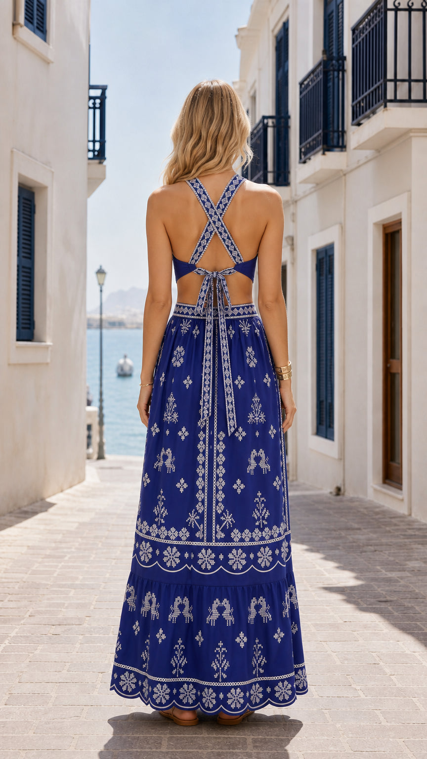 Model wearing royal blue maxi dress back view showing criss-cross straps