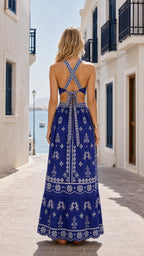 Model wearing royal blue maxi dress back view showing criss-cross straps