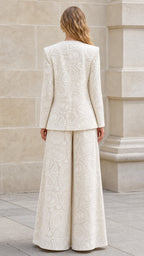 Back view of cream blazer and trousers