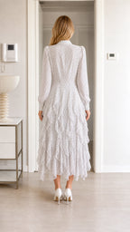 Back view of white polka dot midi dress showing tiered ruffles