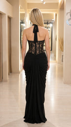 Back view of black halter dress showing back tie and draping