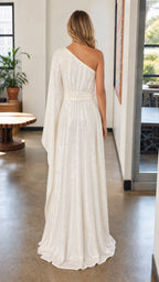 Back view of white sequin maxi dress showing draped cape sleeve