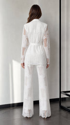 Back view of woman wearing white lace two-piece suit