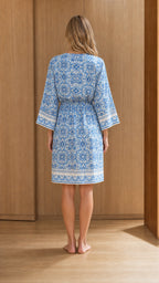Back view of woman wearing blue printed resort dress