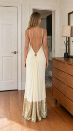 Back view showing open back and ring detail of cream dress