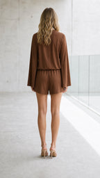 Back view of brown romper showing tailored shorts