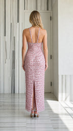 Back view of pink sequin halter maxi dress showing back slit and straps