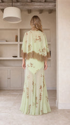 Model wearing mint green floral maxi dress, back view