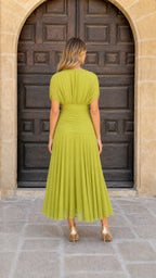 Back view of model in lime green ruched midi dress