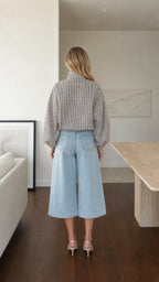 Back view of model wearing white plaid high-neck blouse