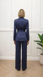 Back view of woman wearing navy satin suit