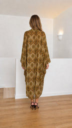 Model wearing olive paisley kaftan dress back view