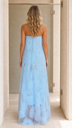 Model wearing light blue strapless sequin floral maxi dress back view