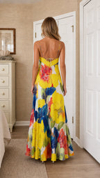 Back view of model wearing bright yellow floral maxi dress