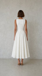 Back view of woman wearing white pleated dress