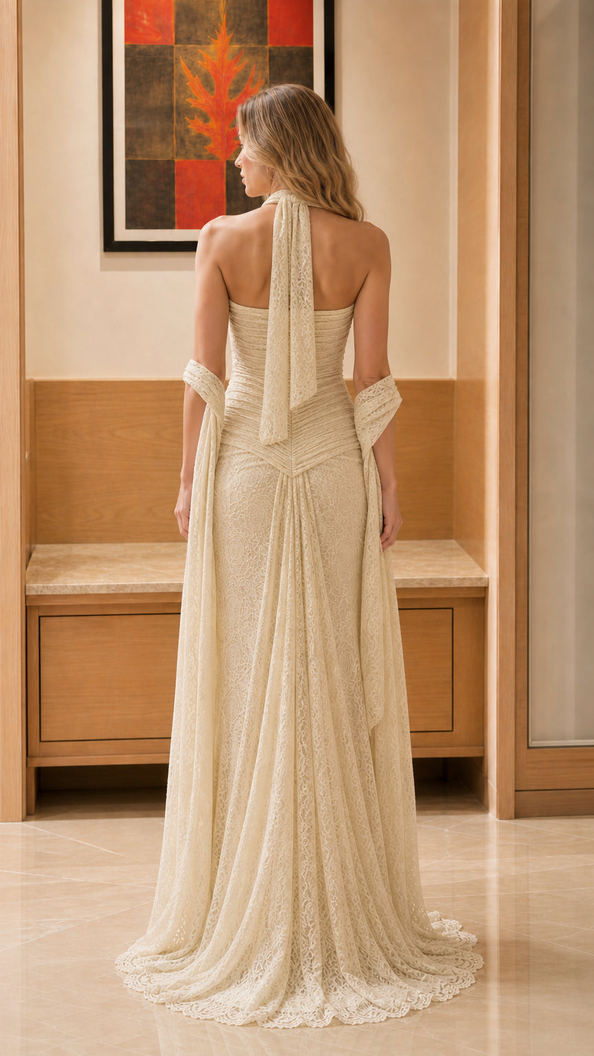 Back view showcasing the halter tie and sweeping hem of the champagne gown