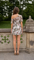 Back view of woman wearing white floral romper