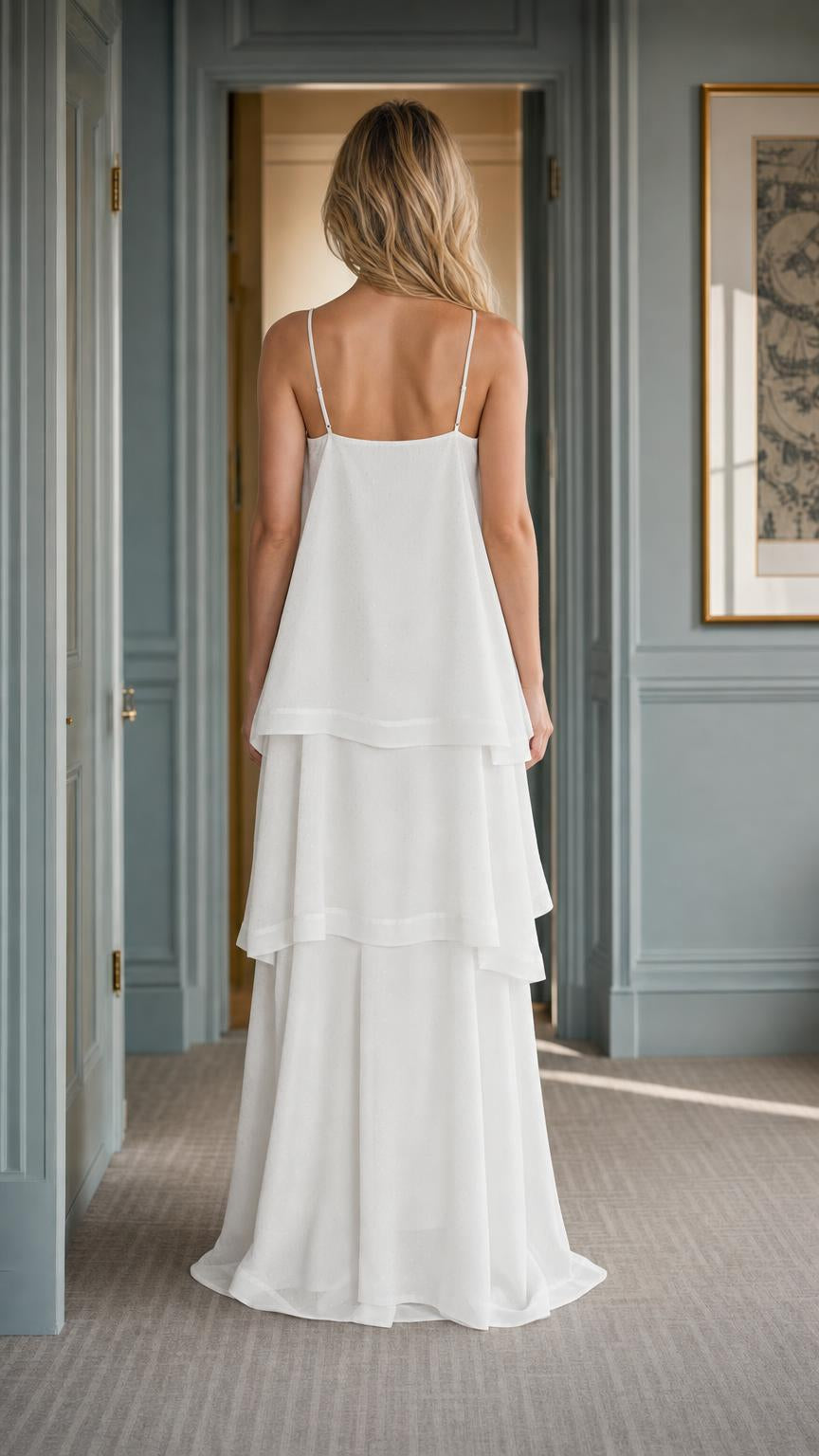 Back view of woman wearing white tiered maxi dress