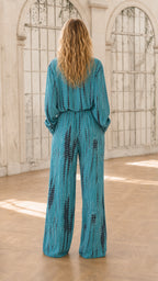 Back view of model in teal tie-dye jumpsuit