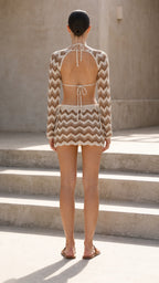Back view showing open back shrug and mini skirt