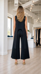 Model wearing black fringe pant set, back view