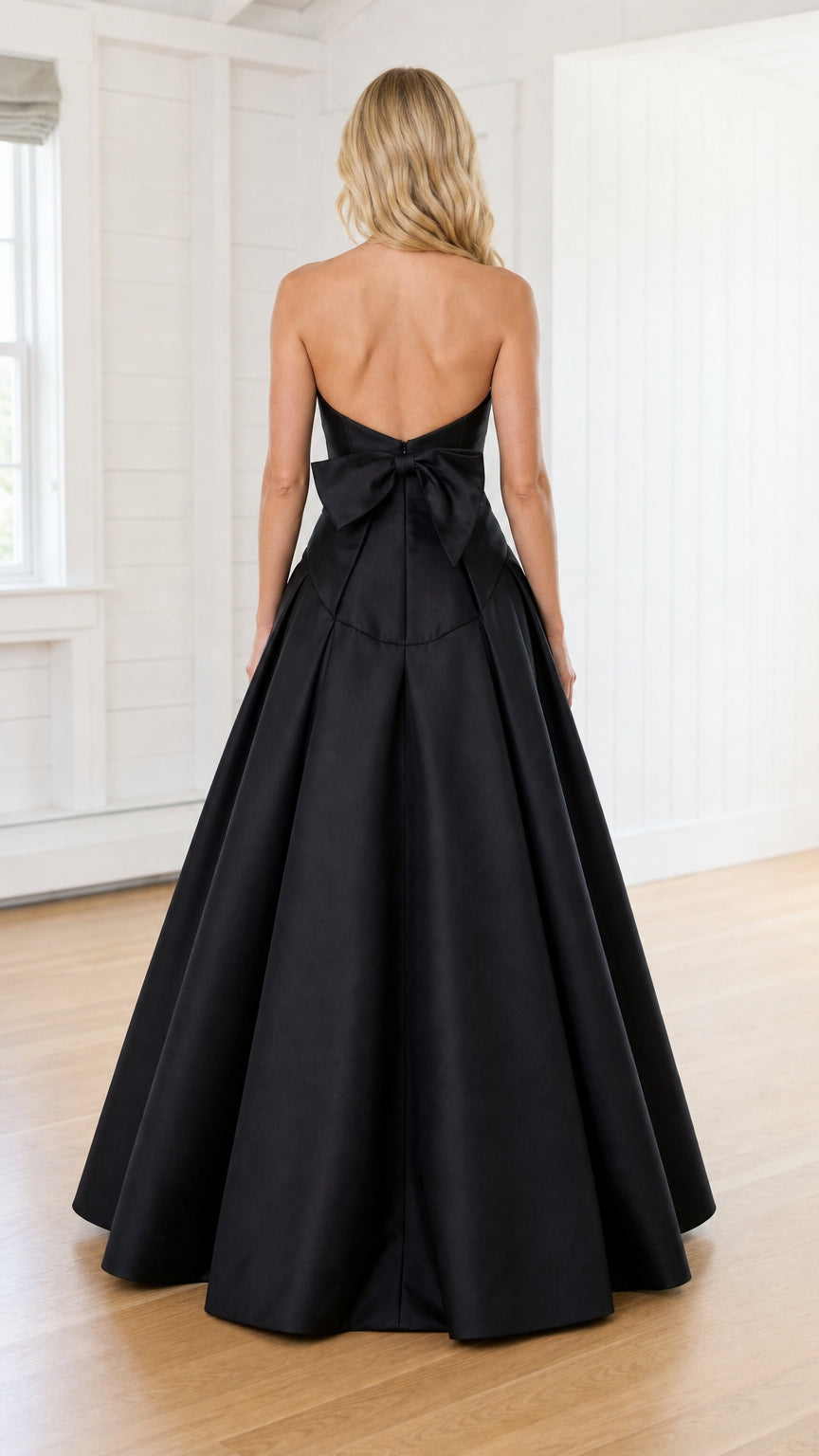 Back view showcasing oversized bow on black evening gown