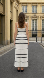Back view of woman wearing white striped knit cami maxi dress