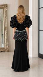 Back view of black maxi gown with voluminous sleeves
