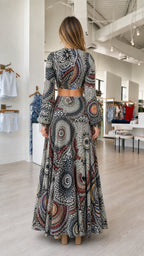 Back view of model showcasing the back of the multi-color top and skirt