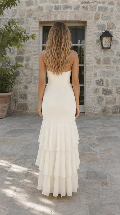 Back view of cream halter maxi dress showing cascading ruffles