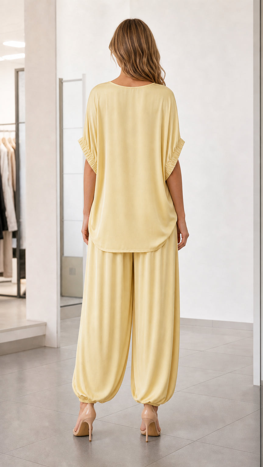 Back view of model wearing yellow matching top and pants set